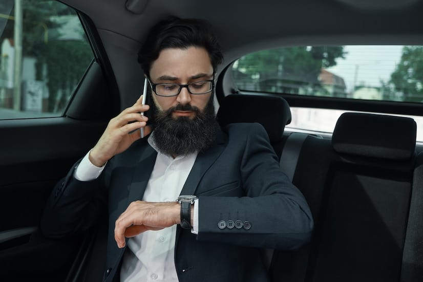businessman-while-traveling-by-car-back-seat-using-smartphone_158595-4237