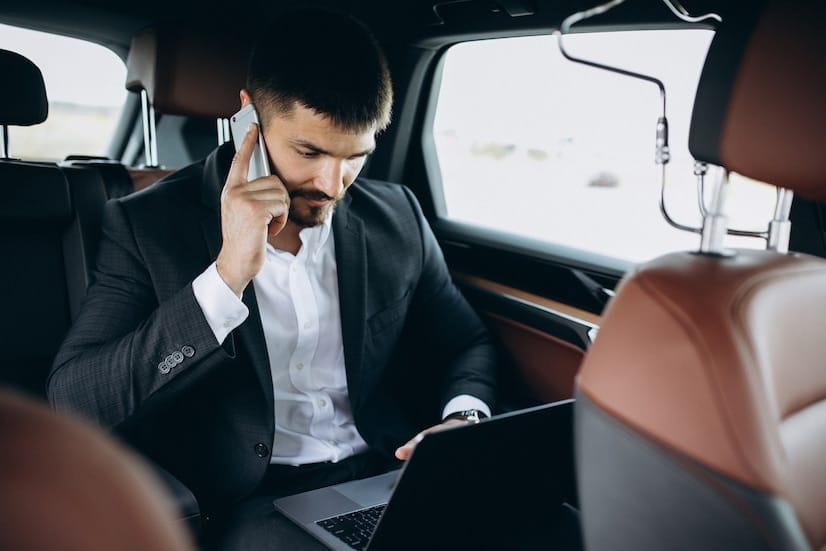 handsome-business-man-working-computer-car_1303-16421