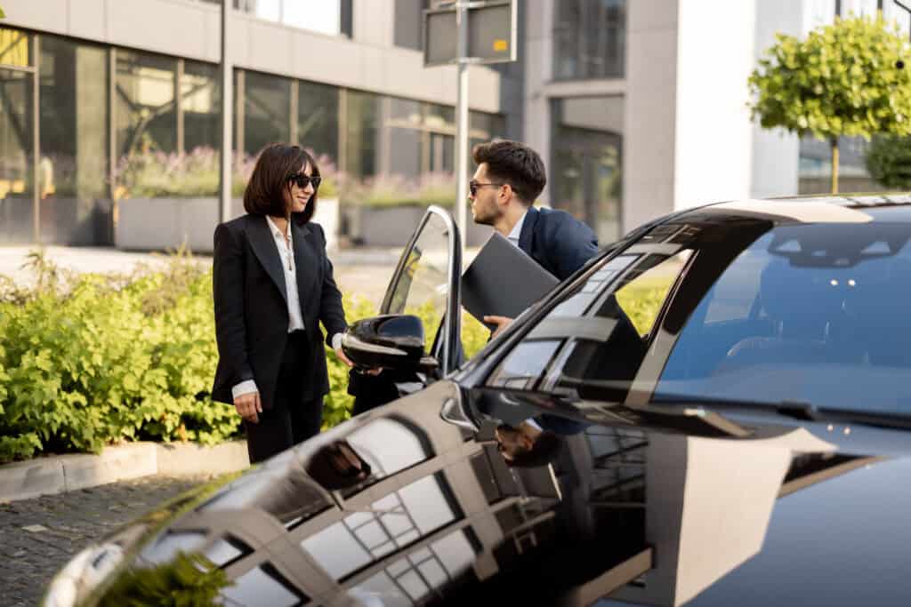 Luxury chauffeur service with professional driver and premium vehicle in city environment.