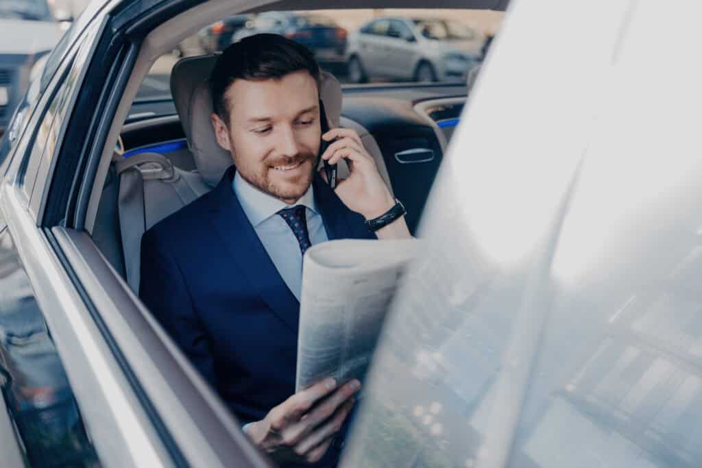 Luxury chauffeur service with professional driver in a high-end vehicle.