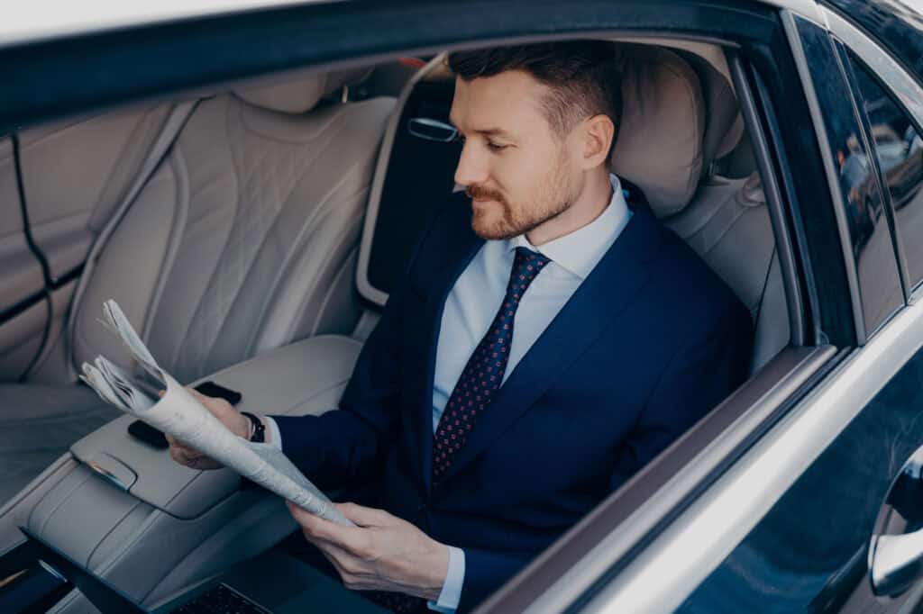 Luxury chauffeur service with professional driver in a high-end car.