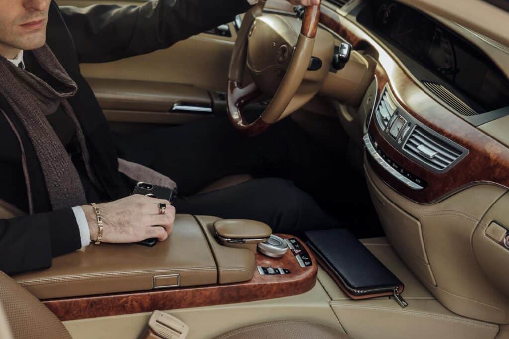Luxury chauffeur service interior with a driver at the wheel.